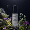 Petal pain relief gel roller bottle on a natural background with flowers